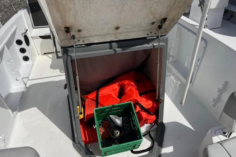 Slide: The Image of Open storage compartment on 2020 Hurricane Center Console 19 OB boat with life jackets and equipment. - 5