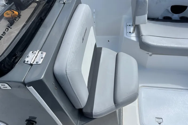 Slide: The Image of 2020 Hurricane Center Console 19 OB boat interior with gray seating and console details. - 6