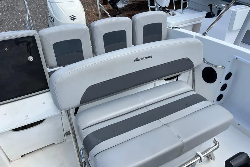 Slide: The Image of 2020 Hurricane Center Console 19 OB boat interior with gray seating and Suzuki engine. - 8