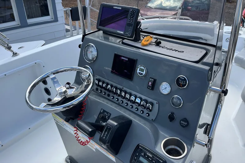 Slide: The Image of Center console of 2020 Hurricane Center Console 19 OB boat with steering wheel and controls. - 9