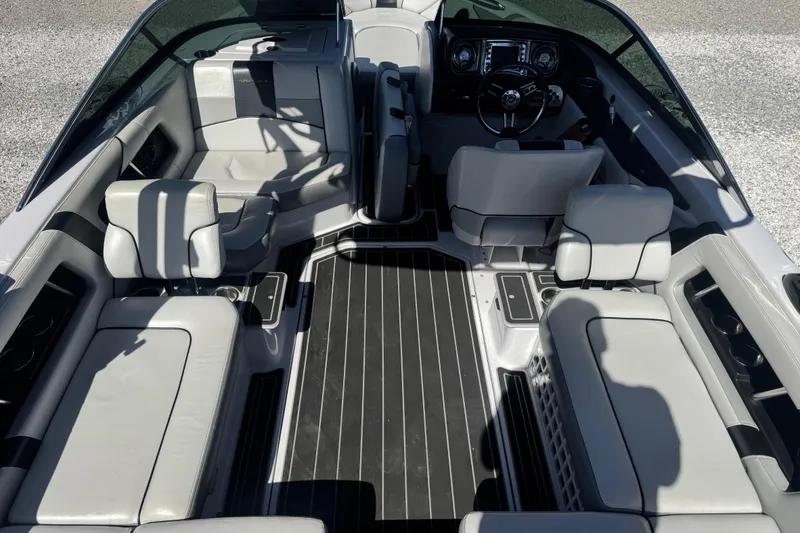 Slide: The Image of Interior of a 2011 Nautique Super Air Nautique 230 boat with sleek seating and modern dashboard. - 13