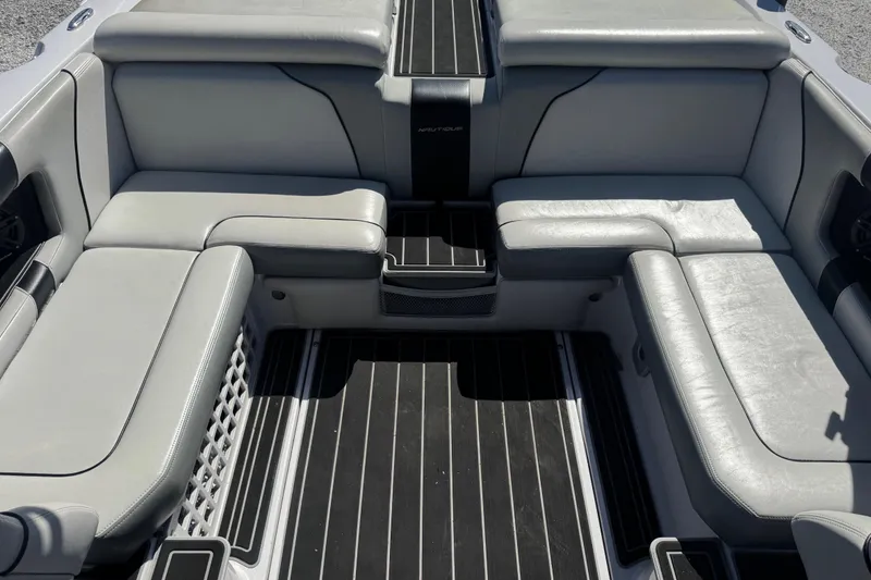 Slide: The Image of 2011 Nautique Super Air Nautique 230 interior with gray seating and black flooring. - 16