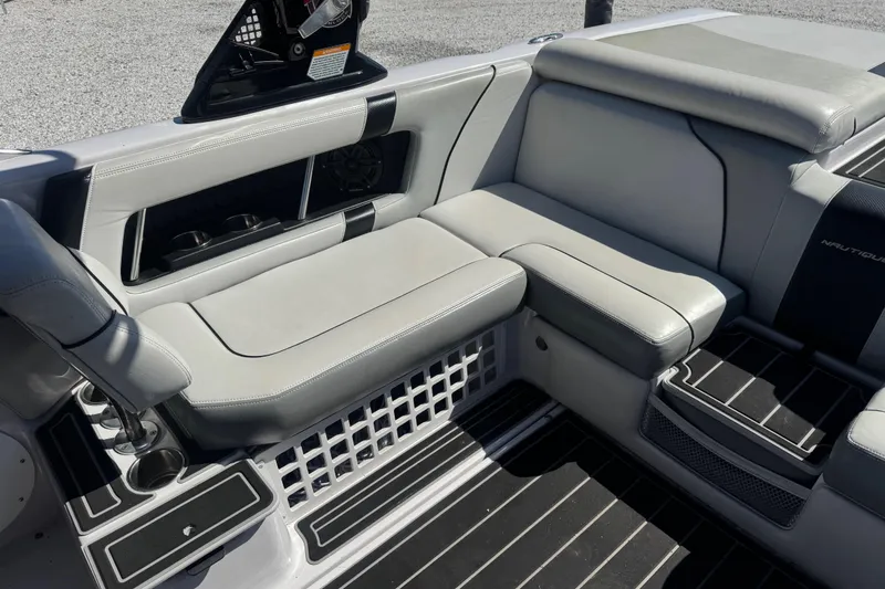 Slide: The Image of Interior seating of 2011 Nautique Super Air Nautique 230 boat, featuring gray upholstery. - 17