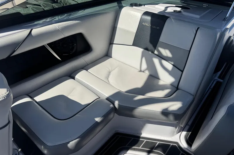 Slide: The Image of Interior seating of 2011 Nautique Super Air Nautique 230 boat, featuring sleek gray upholstery. - 18