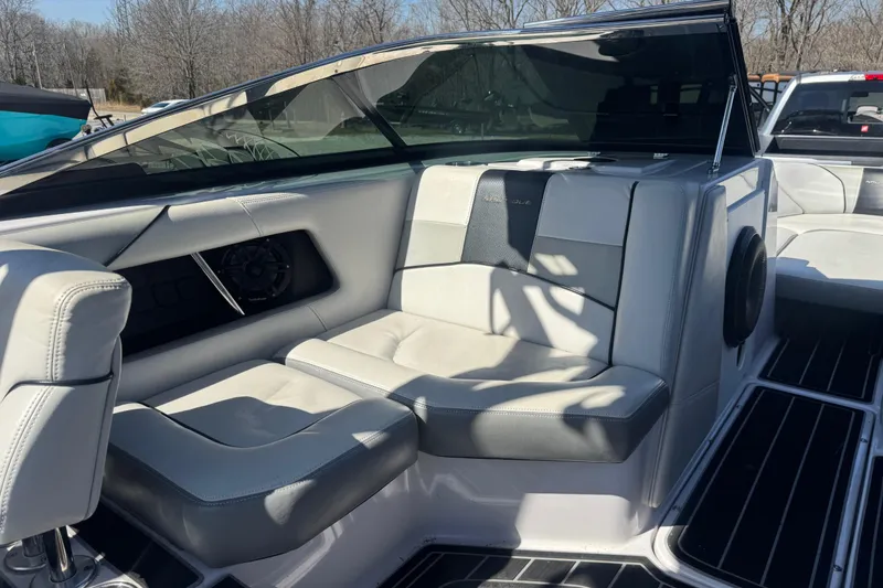 Slide: The Image of 2011 Nautique Super Air Nautique 230 interior with white seating and speaker system. - 20