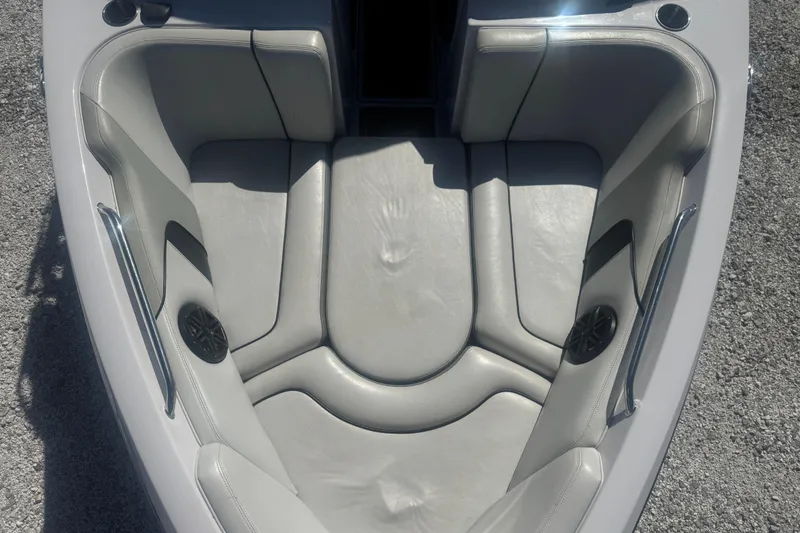 Slide: The Image of 2011 Nautique Super Air Nautique 230 boat interior with gray seating and speakers. - 21