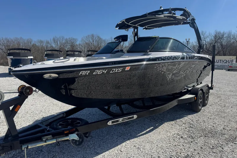 Slide: The Image of 2011 Nautique Super Air Nautique 230 boat on trailer, parked outdoors. - 8