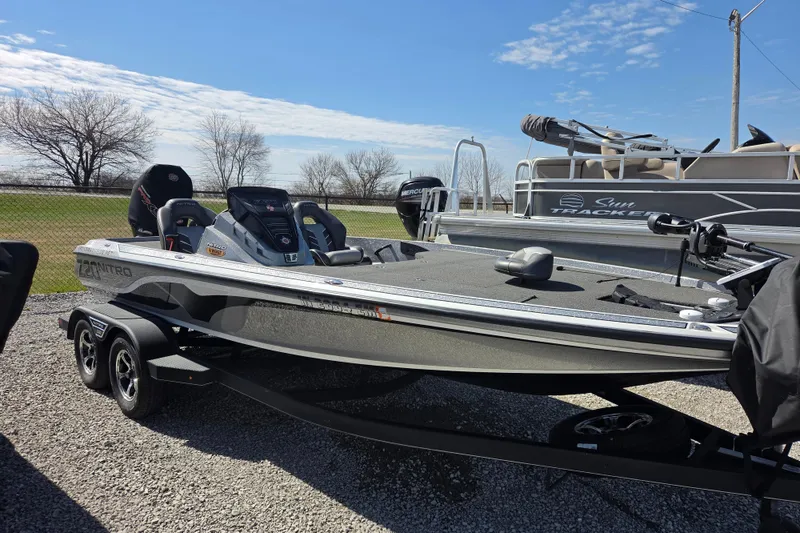 The Image of 2023 Nitro Z20 fishing boat on trailer under clear blue sky. - 1