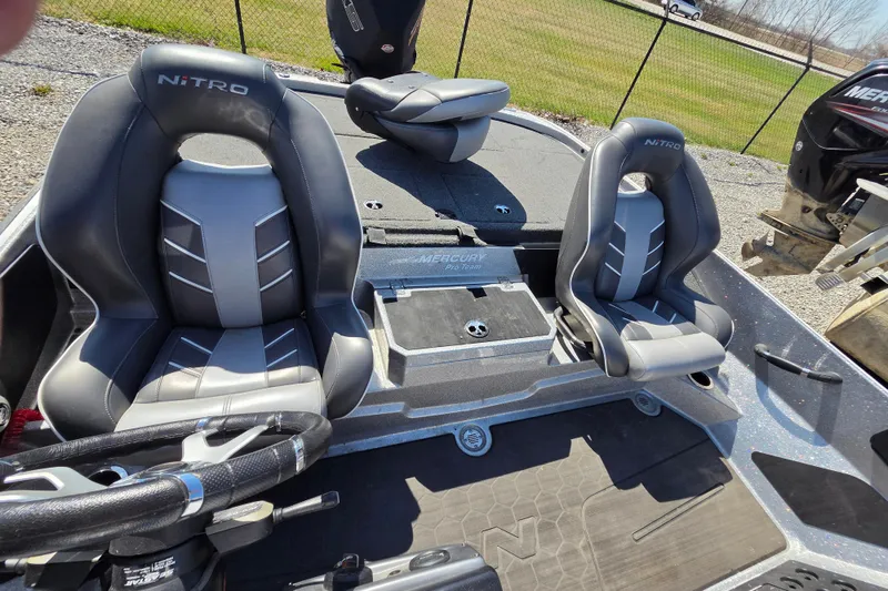 Slide: The Image of 2023 Nitro Z20 boat interior with sleek gray seating and steering wheel. - 11