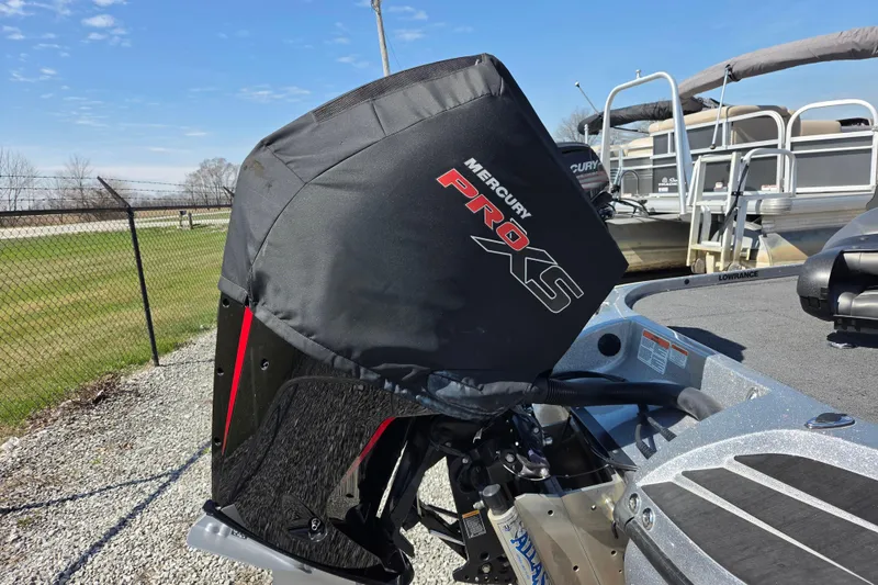 Slide: The Image of 2023 Nitro Z20 boat with Mercury Pro XS engine cover, parked outdoors. - 13