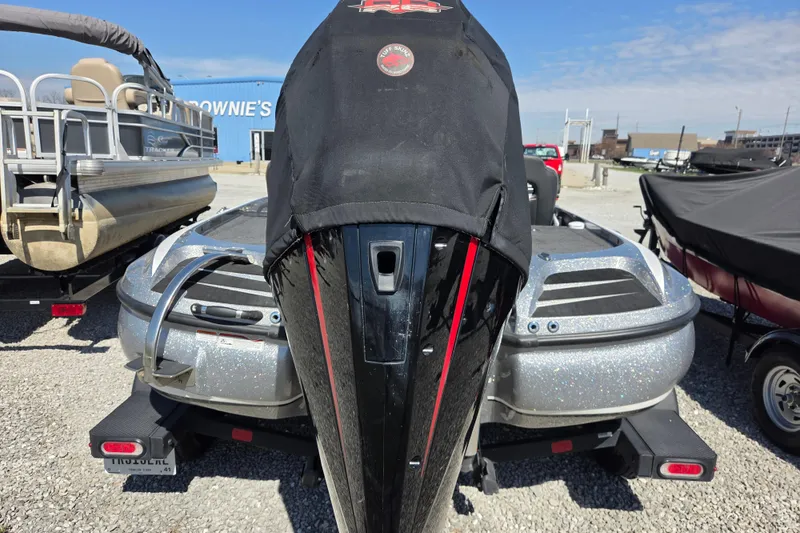 Slide: The Image of 2023 Nitro Z20 boat with covered engine, parked on gravel lot. - 16