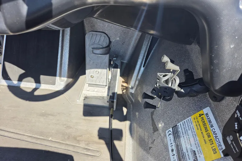 Slide: The Image of Interior view of a 2023 Nitro Z20 boat, showing foot pedal and capacity label. - 9