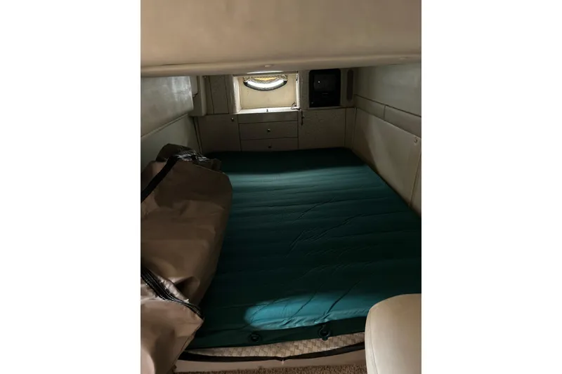 Slide: The Image of Interior cabin of a 2001 Doral 330se boat with a bed and storage. - 10