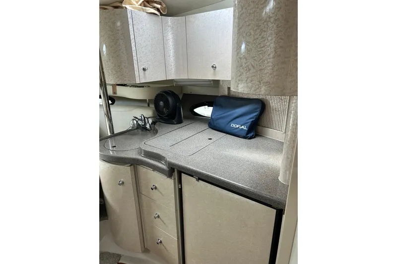 Slide: The Image of 2001 Doral 330se boat interior kitchen with cabinets, sink, and countertop. - 12