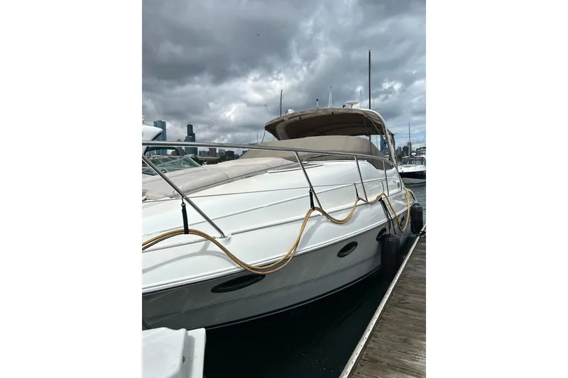 Slide: The Image of 2001 Doral 330se yacht docked under cloudy skies. - 4