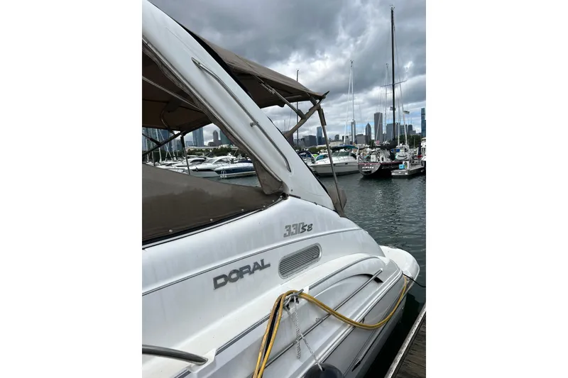 Slide: The Image of 2001 Doral 330se boat docked in marina with city skyline background. - 5