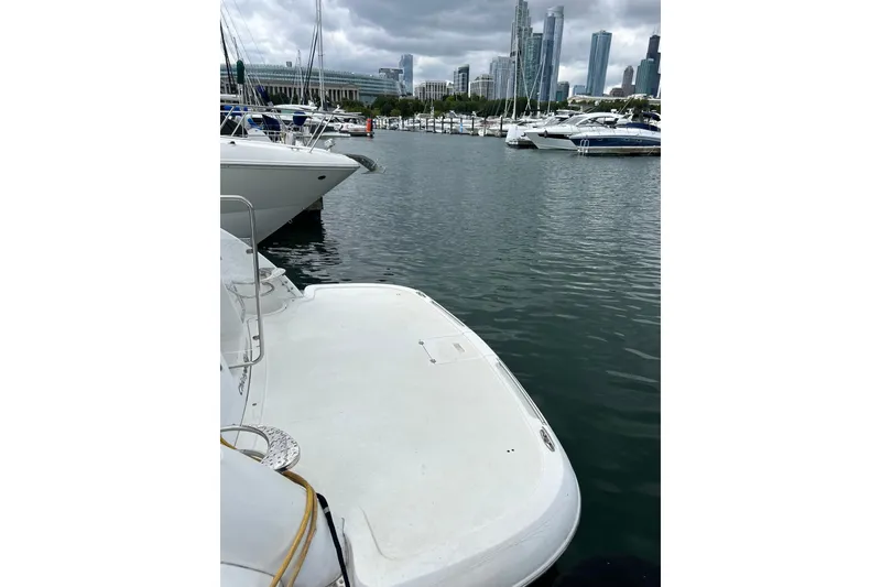 Slide: The Image of 2001 Doral 330se boat docked in a marina with city skyline background. - 6