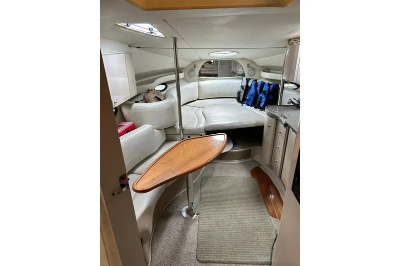 Slide: The Image of Interior of 2001 Doral 330se boat with seating, table, and life jackets. - 8