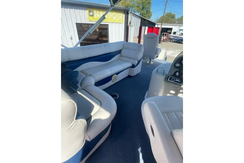 Slide: The Image of 2009 Premier 221 Cast-A-Way boat interior with white seating and blue accents. - 2