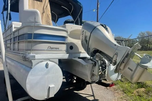 Slide: The Image of 2009 Premier 221 Cast-A-Way pontoon boat with outboard motor, docked outdoors. - 8