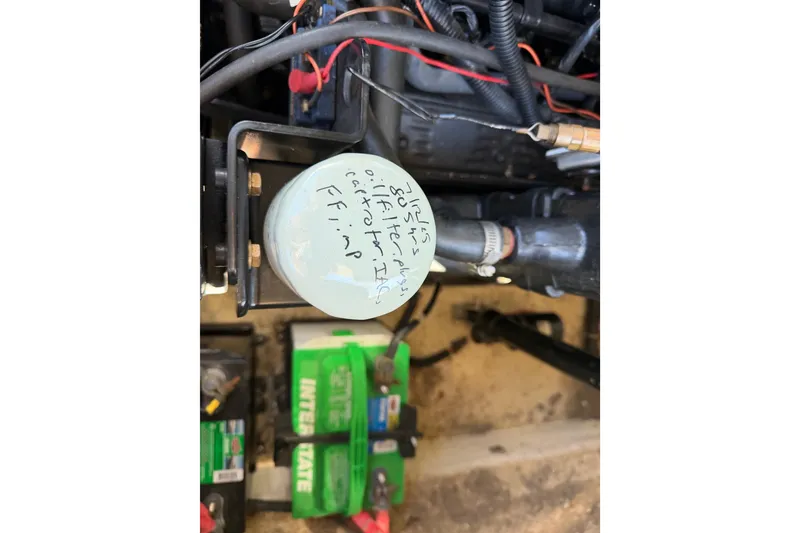 Slide: The Image of Engine compartment of a 2003 Rinker 282 Captiva Bowrider with visible oil filter and battery. - 13