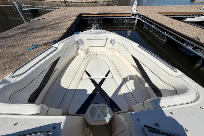 Slide: The Image of 2003 Rinker 282 Captiva Bowrider boat interior with white seating at dock. - 16