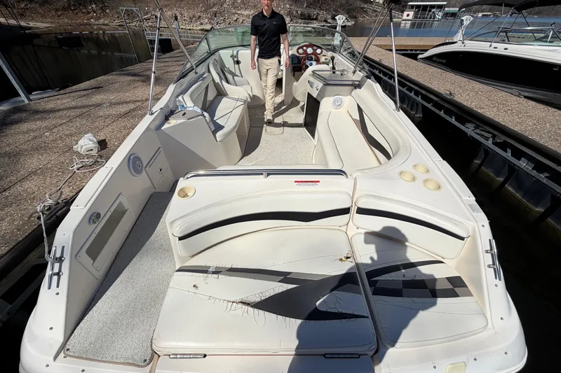 Slide: The Image of 2003 Rinker 282 Captiva Bowrider with spacious seating and visible wear on upholstery. - 20