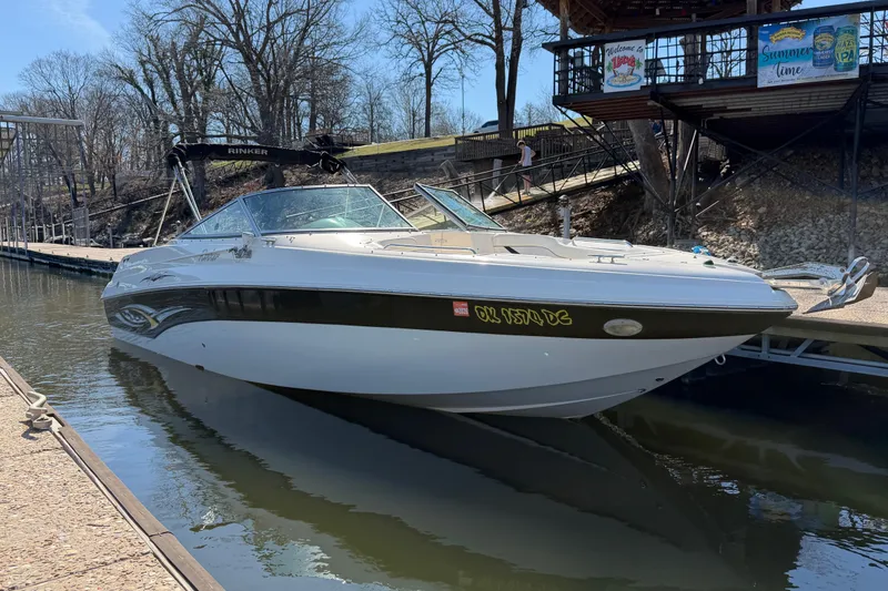 Slide: The Image of 2003 Rinker 282 Captiva Bowrider docked at a marina on a sunny day. - 5