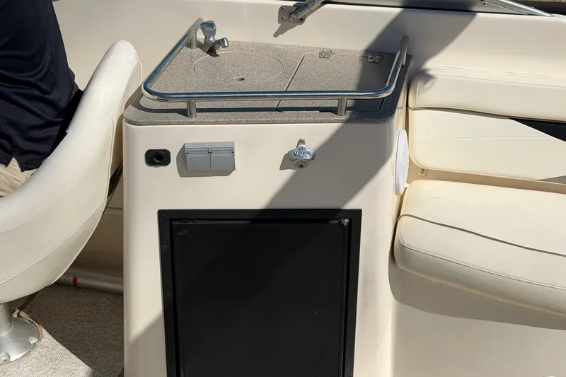 Slide: The Image of 2003 Rinker 282 Captiva Bowrider interior with seating and storage area. - 6