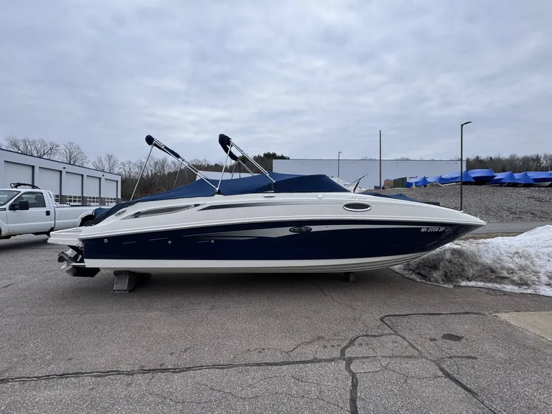 The Image of 2010 Sea Ray 280SD boat parked outdoors on pavement. - 1