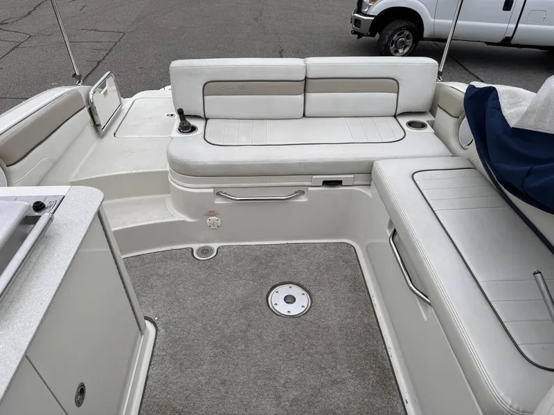 Slide: The Image of Interior of a 2010 Sea Ray 280SD boat with white seating. - 12