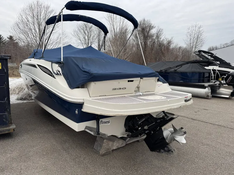 Slide: The Image of 2010 Sea Ray 280SD boat with cover on parking lot. - 2