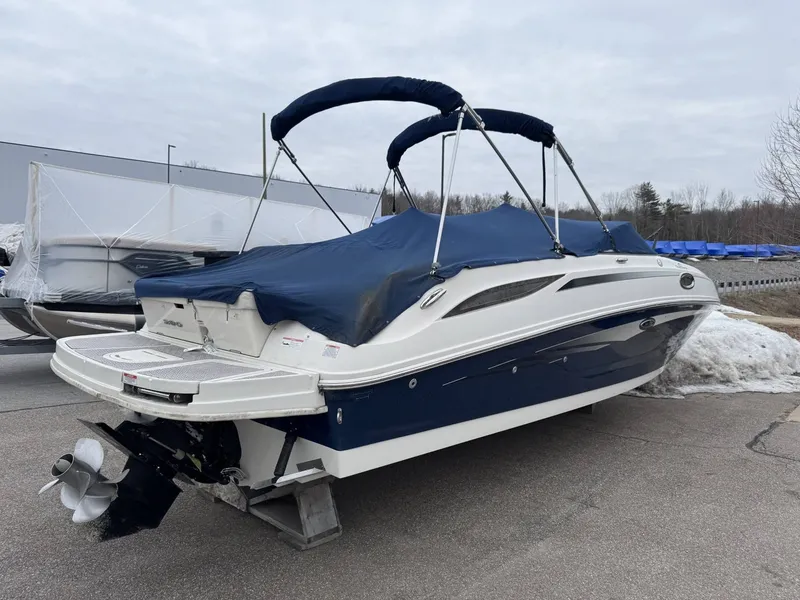 Slide: The Image of 2010 Sea Ray 280SD boat with blue cover on parking lot. - 4