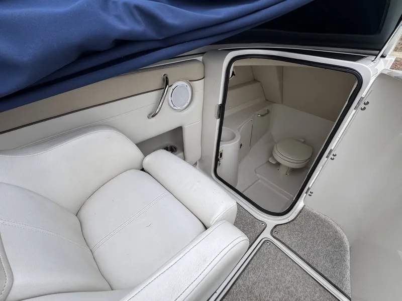 Slide: The Image of Interior of a 2010 Sea Ray 280SD with toilet and seating. - 7