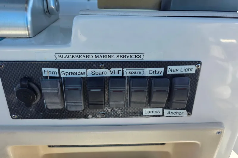 Slide: The Image of Control panel on a 2002 Luhrs 34 Convertible boat with labeled switches. - 12