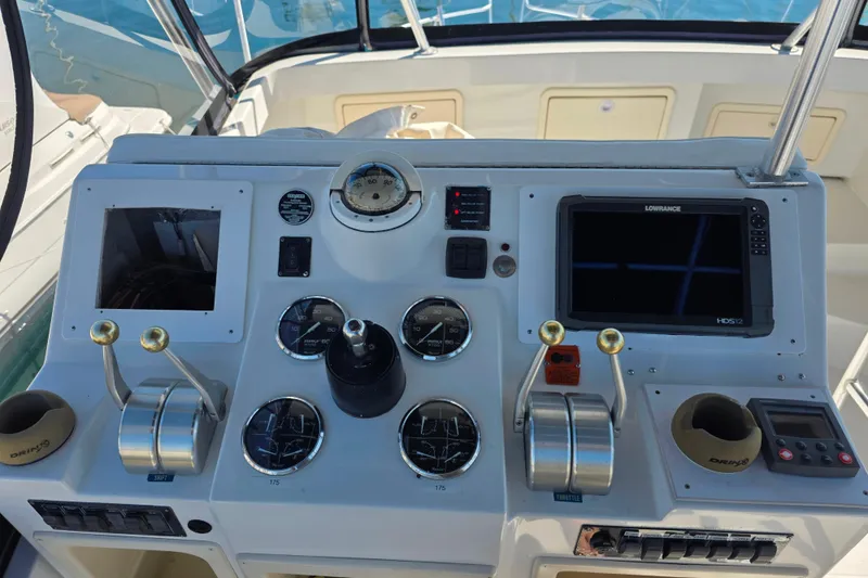 Slide: The Image of Control panel of a 2002 Luhrs 34 Convertible boat with gauges and navigation equipment. - 13