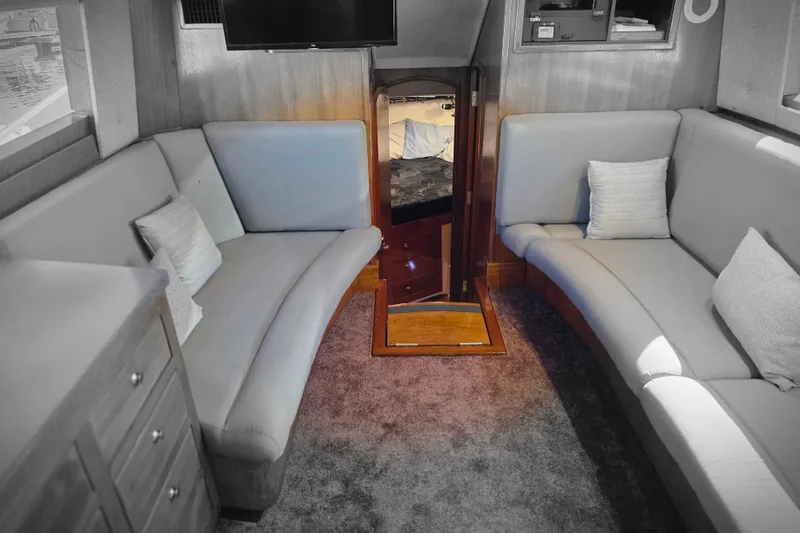 Slide: The Image of Interior of 2002 Luhrs 34 Convertible yacht with cozy seating and elegant wood finishes. - 20