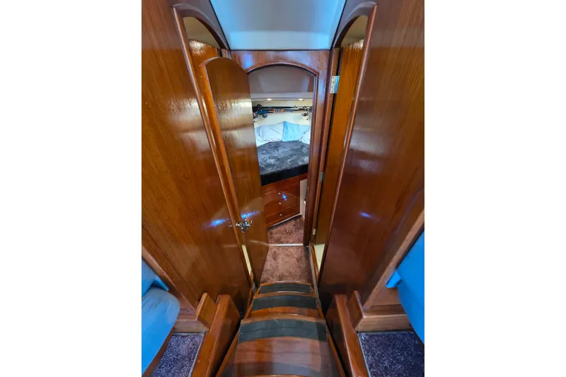 Slide: The Image of Interior view of 2002 Luhrs 34 Convertible yacht, featuring polished wood and cozy cabin space. - 21