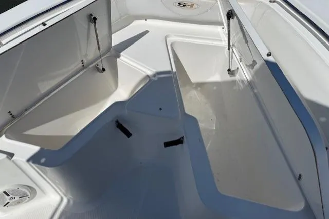Slide: The Image of 2012 Sea Hunt Triton 225 boat interior with open storage compartments. - 15