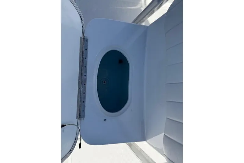 Slide: The Image of Livewell on a 2012 Sea Hunt Triton 225 boat, featuring a white interior. - 17