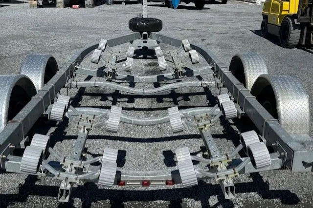 Slide: The Image of Trailer for 2012 Sea Hunt Triton 225 boat, featuring multiple rollers and dual axles. - 18