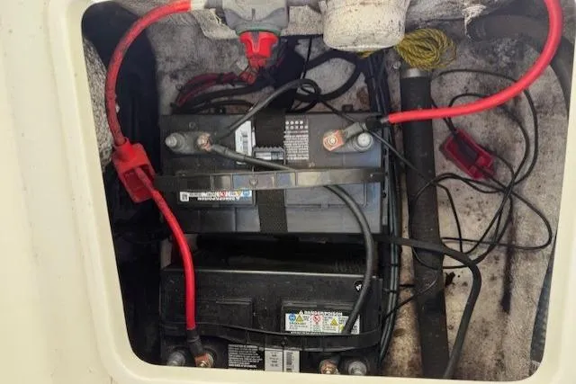 Slide: The Image of Battery compartment of a 2012 Sea Hunt Triton 225 boat with visible wiring. - 8