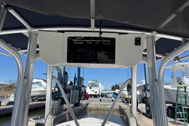 Slide: The Image of 2012 Sea Hunt Triton 225 boat console with canopy at marina. - 9