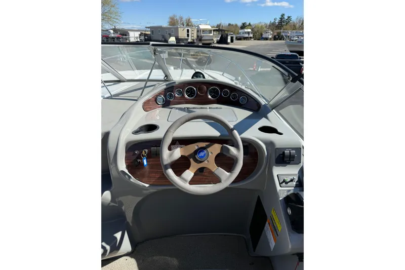 Slide: The Image of 2000 Four Winns 288 Vista boat dashboard with steering wheel and gauges. - 5