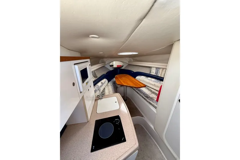 Slide: The Image of Interior of 2000 Four Winns 288 Vista boat with kitchenette and seating area. - 6