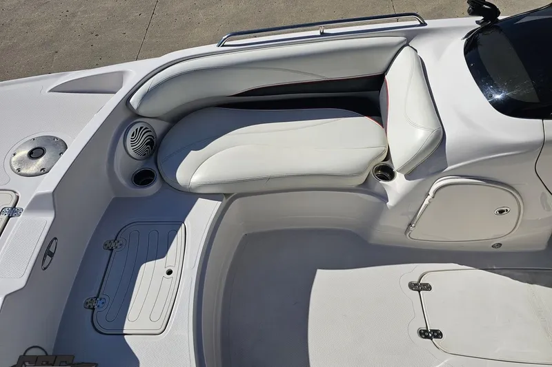 Slide: The Image of 2015 Tahoe 215 Xi boat interior with white seating and storage compartments. - 101