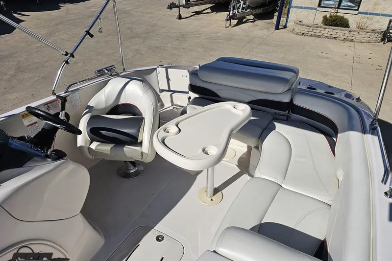 Slide: The Image of Interior of a 2015 Tahoe 215 Xi boat with seating and table. - 103