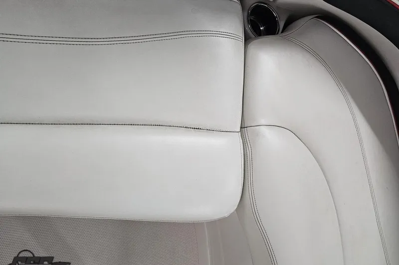 Slide: The Image of White leather seating in a 2015 Tahoe 215 Xi boat, showcasing sleek design and stitching. - 105