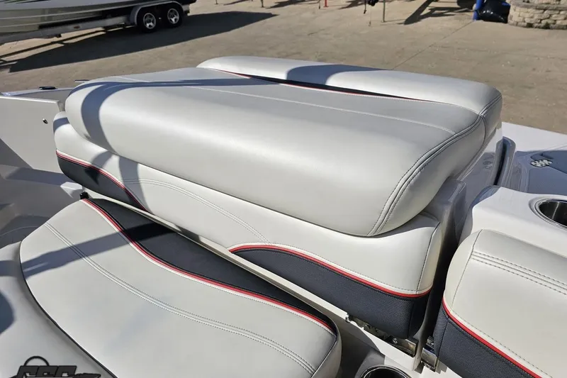 Slide: The Image of 2015 Tahoe 215 Xi boat seat with white and black upholstery, featuring red accents. - 107