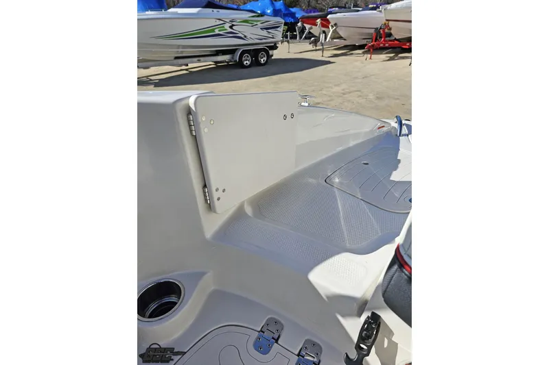 Slide: The Image of 2015 Tahoe 215 Xi boat interior, showcasing seating and deck details in a marina setting. - 108